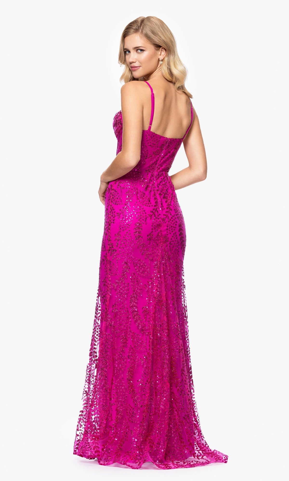 A woman wears the Long Glitter Prom Dress: Blondie Nites 4623BN—a bright pink, floor-length sparkly gown—and stands with her back turned, looking over her shoulder against a plain white background.